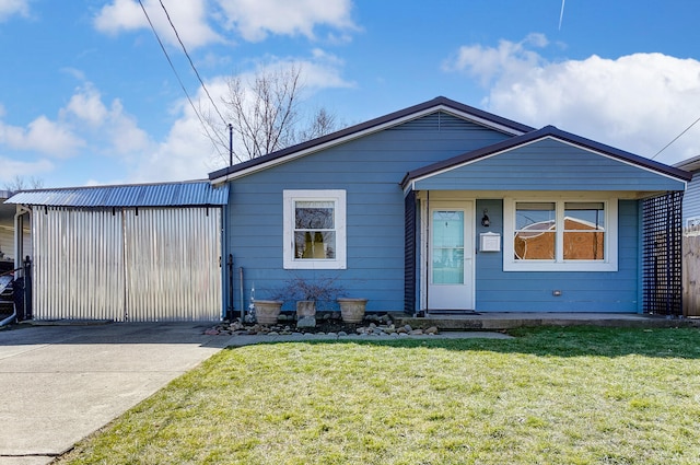 view of front of property with metal roof and a front lawn