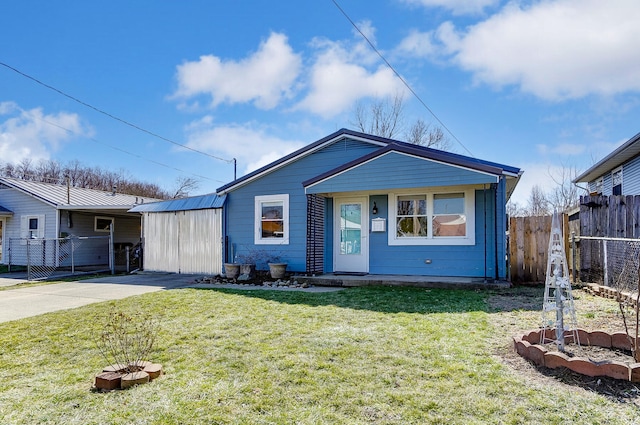 view of front of home featuring a front yard, fence, and metal roof