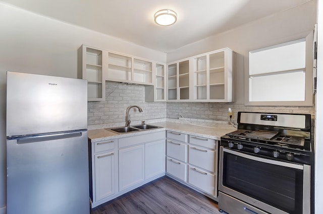 kitchen with open shelves, a sink, decorative backsplash, light countertops, and appliances with stainless steel finishes