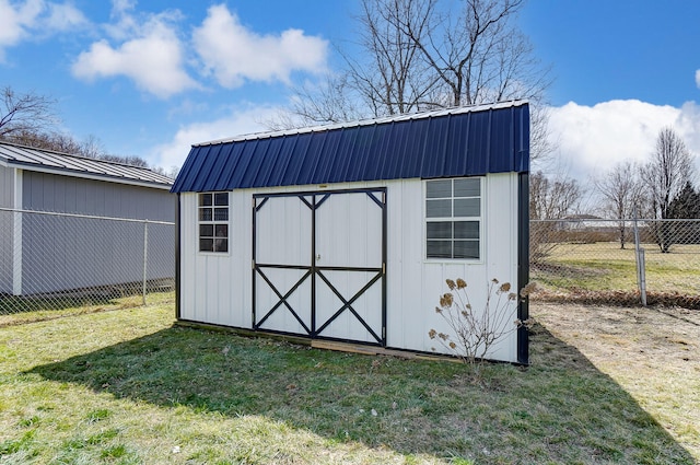 view of shed featuring fence