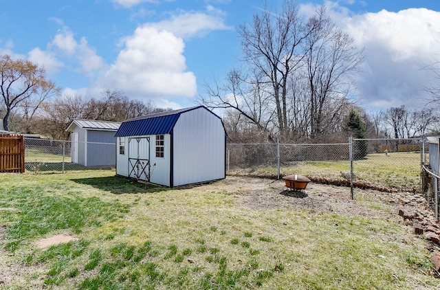 view of yard with a storage unit, an outbuilding, and a fenced backyard