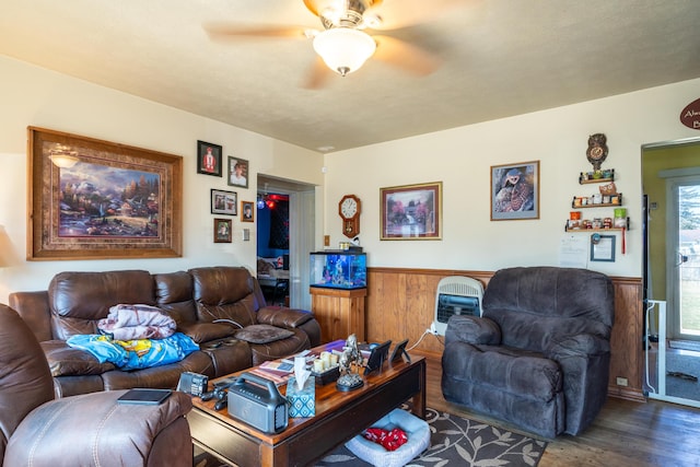 living room with dark wood-type flooring, wainscoting, and ceiling fan