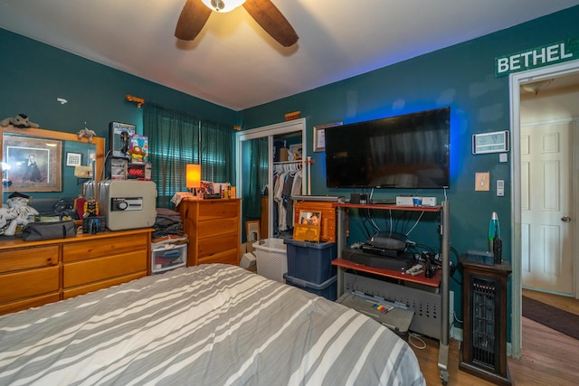 bedroom featuring a ceiling fan, a closet, and wood finished floors