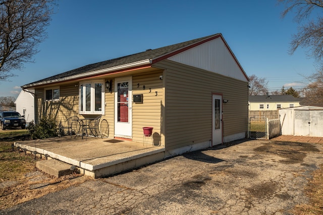 view of front of home featuring a patio area and fence