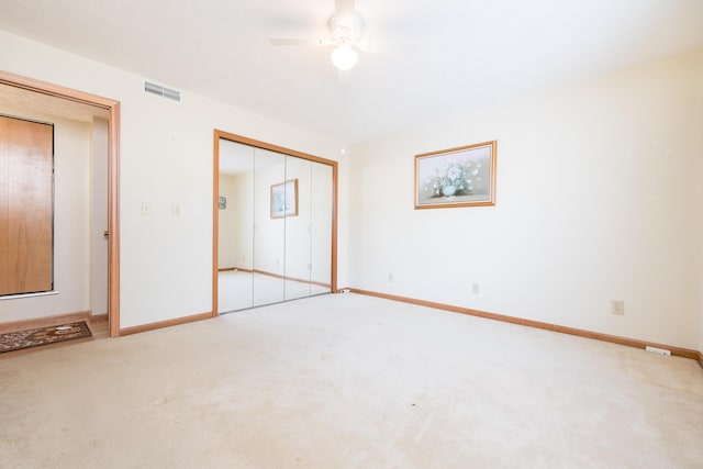 unfurnished bedroom with ceiling fan, carpet, and a closet