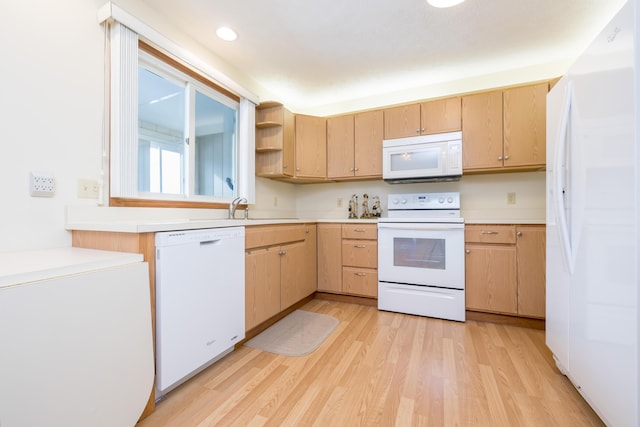 kitchen featuring sink, light brown cabinetry, white appliances, and light hardwood / wood-style flooring