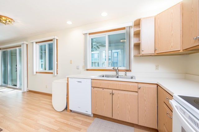 kitchen featuring light brown cabinetry, sink, dishwasher, and light wood-type flooring