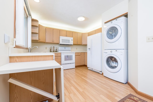 kitchen with stacked washer and dryer, white appliances, light hardwood / wood-style flooring, sink, and light brown cabinetry