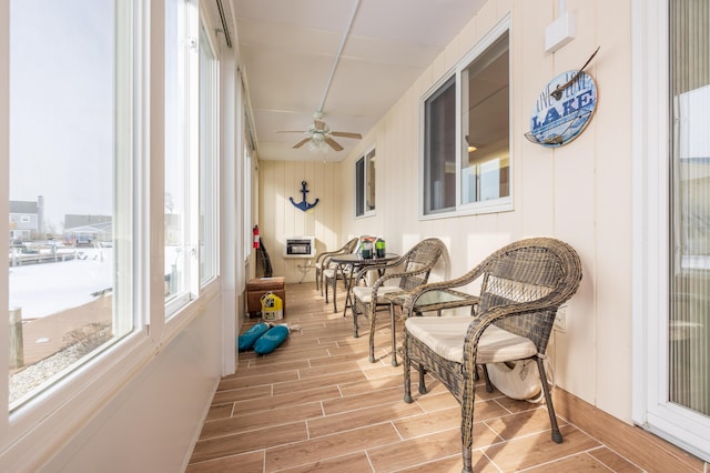 sunroom featuring ceiling fan