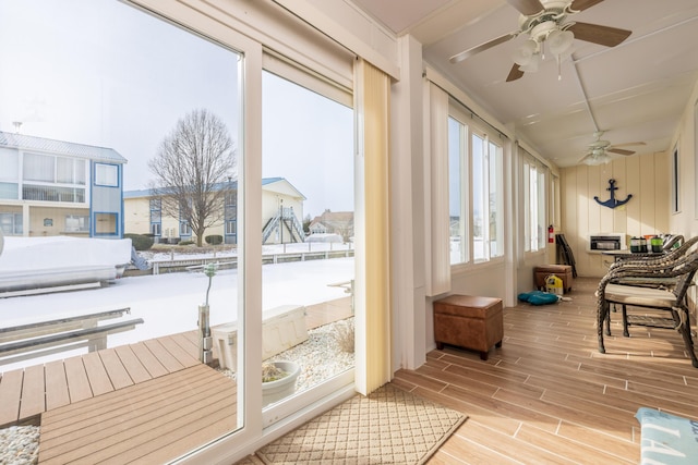 sunroom featuring ceiling fan