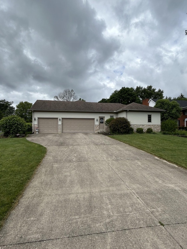 207 Meadowbrook Ln, Saint Marys, OH 45885 - view of front of home featuring driveway, stone siding, a front yard, a garage, and stucco siding