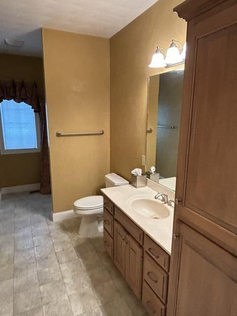 207 Meadowbrook Ln, Saint Marys, OH 45885 - bathroom with toilet, vanity, and baseboards