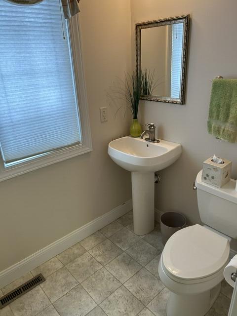 207 Meadowbrook Ln, Saint Marys, OH 45885 - half bath featuring toilet, tile patterned floors, and baseboards