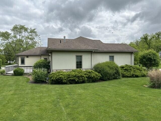 207 Meadowbrook Ln, Saint Marys, OH 45885 - rear view of house with a yard, stucco siding, and a wooden deck