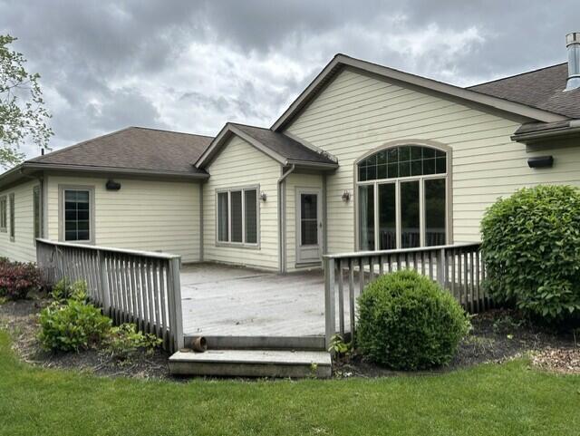 207 Meadowbrook Ln, Saint Marys, OH 45885 - back of property with a wooden deck, a lawn, and roof with shingles