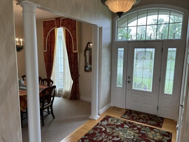 207 Meadowbrook Ln, Saint Marys, OH 45885 - entryway with ornate columns, light wood-type flooring, and baseboards