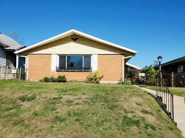 view of side of home featuring a lawn