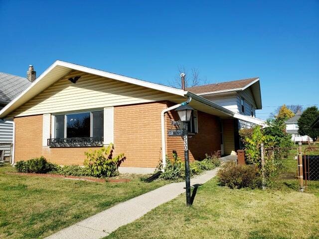 view of property exterior with a lawn