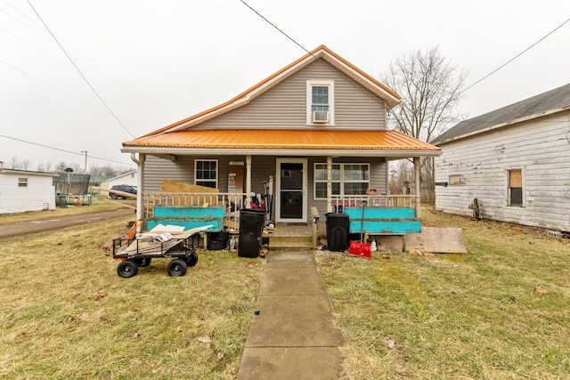 view of front of property featuring a porch, a front yard, a trampoline, and cooling unit