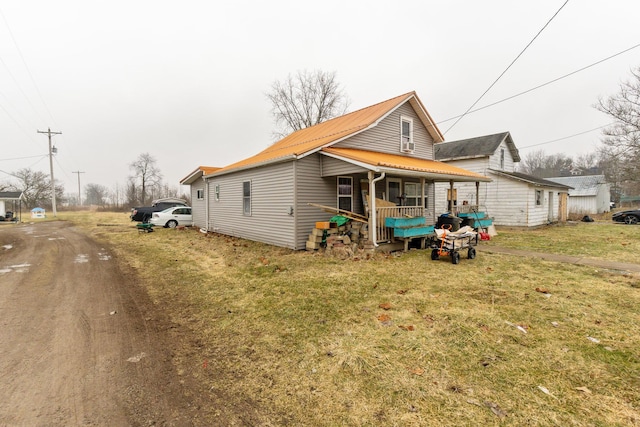 exterior space featuring a front yard and covered porch