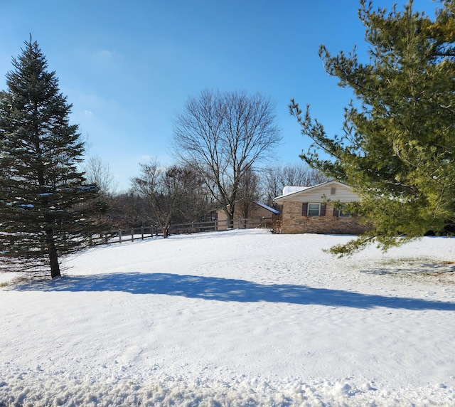 view of yard layered in snow