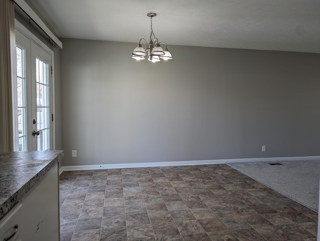 1124 Bookwalter Ave, New Carlisle, OH 45344 - unfurnished dining area with baseboards, a chandelier, and stone finish floors