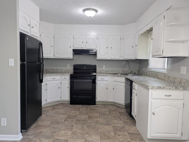 1124 Bookwalter Ave, New Carlisle, OH 45344 - kitchen with black appliances, a sink, under cabinet range hood, white cabinetry, and a textured ceiling