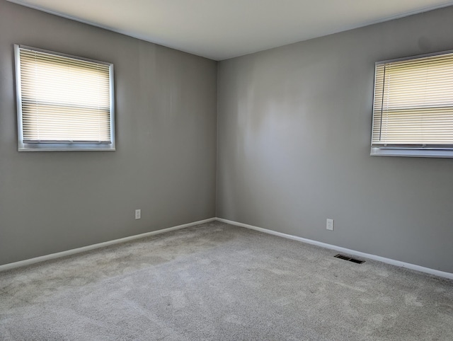 1124 Bookwalter Ave, New Carlisle, OH 45344 - spare room featuring healthy amount of natural light, carpet flooring, and baseboards