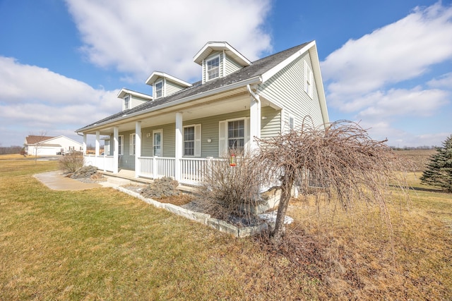 view of front of house featuring a porch, a garage, and a front lawn