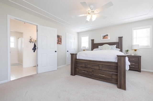 carpeted bedroom featuring multiple windows and ceiling fan