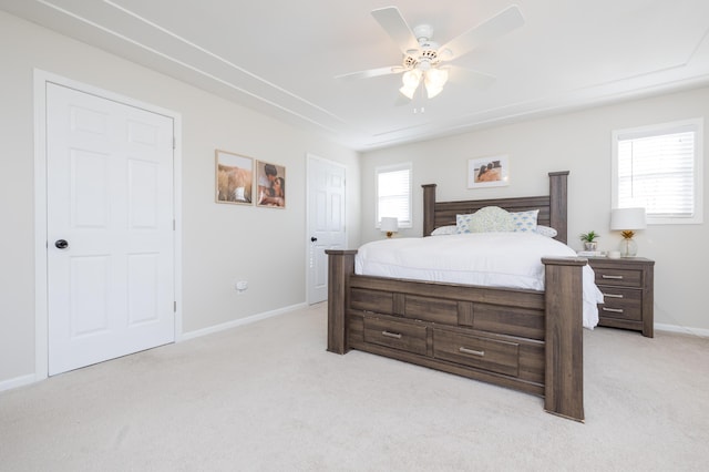 bedroom with ceiling fan and light colored carpet