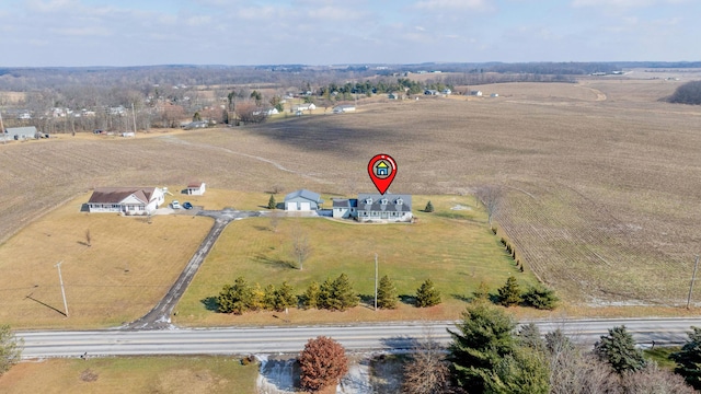 birds eye view of property with a rural view