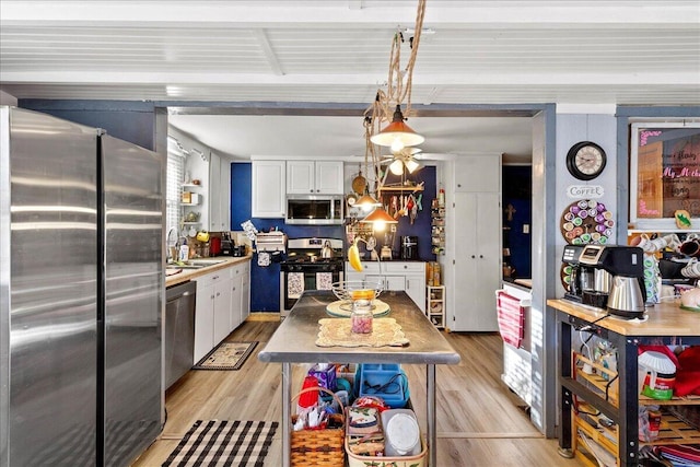 kitchen featuring a sink, light wood-style flooring, white cabinetry, and stainless steel appliances