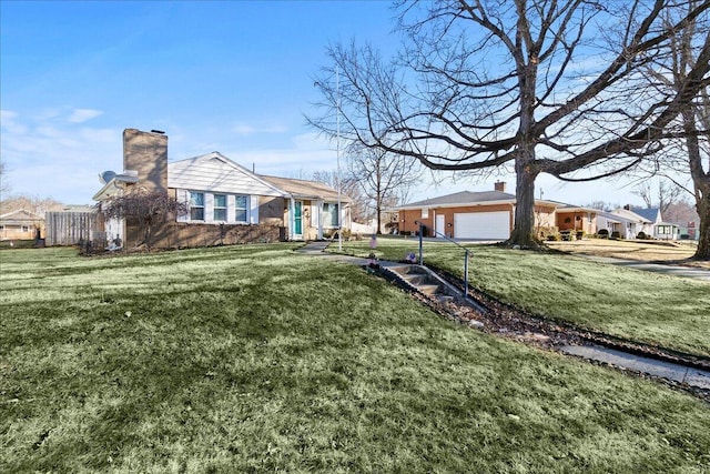 view of front of home featuring a garage, a residential view, a front lawn, and a chimney