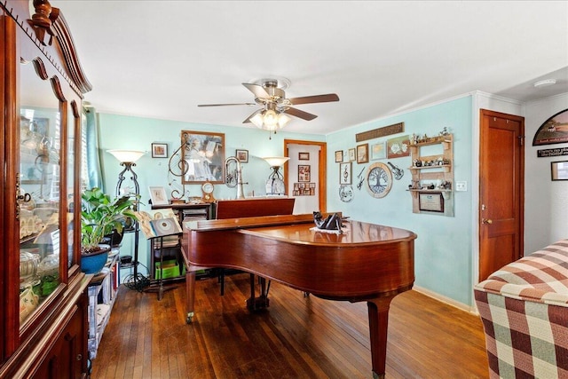 rec room featuring hardwood / wood-style flooring, a ceiling fan, and baseboards