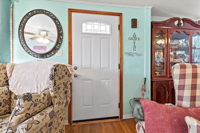 entryway with ornamental molding, ceiling fan, and wood finished floors