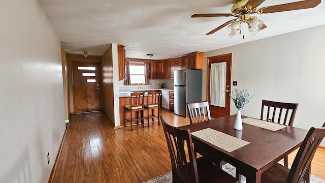 dining area featuring ceiling fan and light hardwood / wood-style flooring