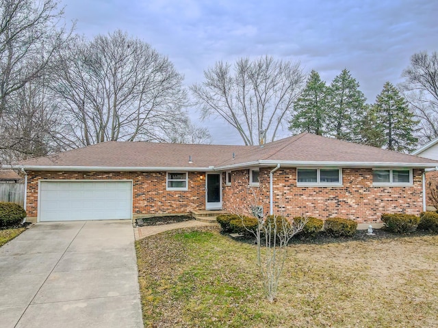 ranch-style home featuring a garage and a front lawn