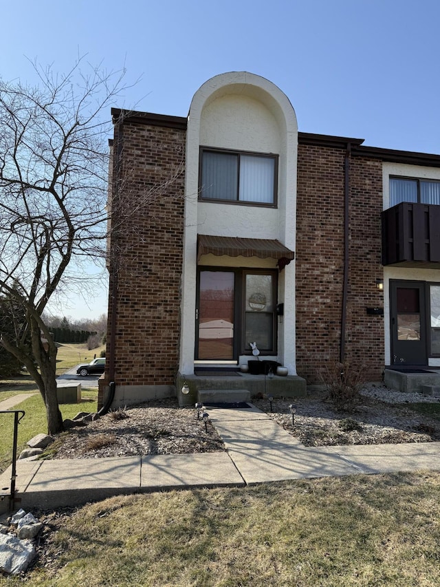 view of front of property with entry steps and brick siding