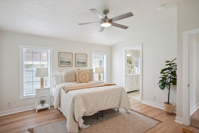 11579 Cooper Ave, Lakeview, OH 43331 - bedroom with multiple windows, light wood-style flooring, ceiling fan, vaulted ceiling, and ensuite bathroom