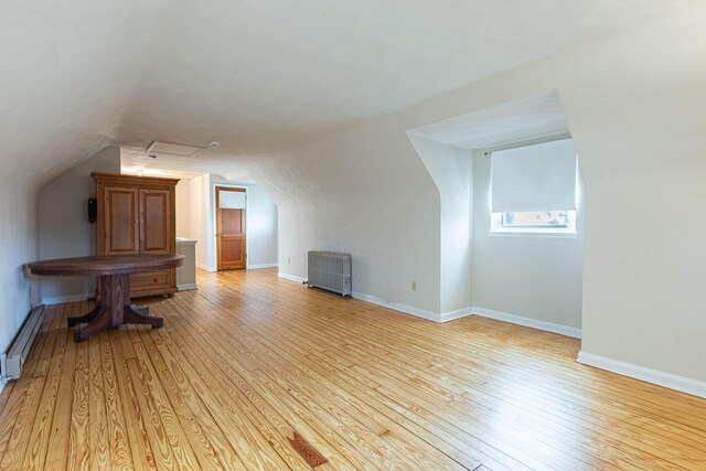 306 S 7th St, Miamisburg, OH 45342 - bonus room featuring baseboards, a baseboard radiator, vaulted ceiling, and light wood-type flooring