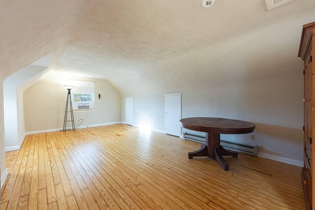 306 S 7th St, Miamisburg, OH 45342 - additional living space with baseboards, baseboard heating, vaulted ceiling, and light wood-style flooring