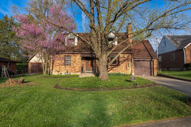 306 S 7th St, Miamisburg, OH 45342 - view of front of home featuring a chimney, brick siding, a front lawn, concrete driveway, and an attached garage