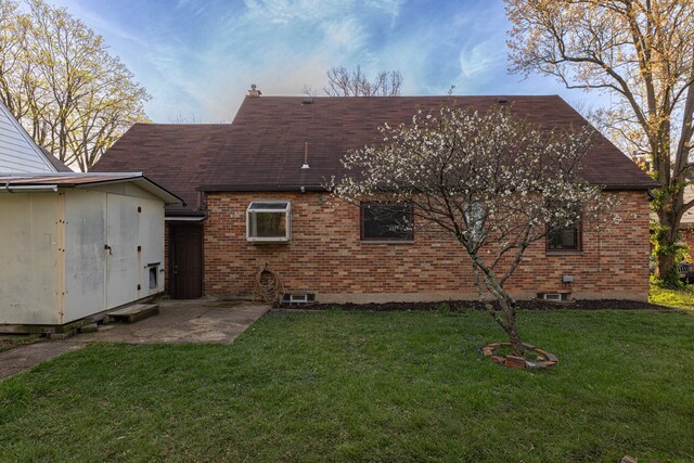 306 S 7th St, Miamisburg, OH 45342 - rear view of house with a lawn, brick siding, an outdoor structure, and roof with shingles