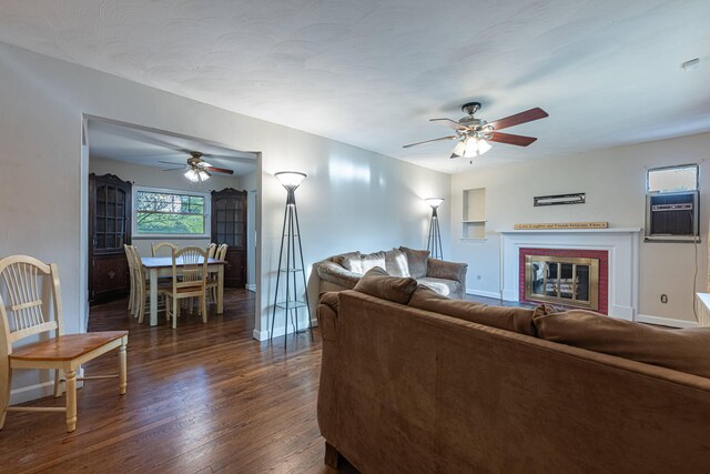 306 S 7th St, Miamisburg, OH 45342 - living room with a brick fireplace, dark wood-style flooring, ceiling fan, and baseboards