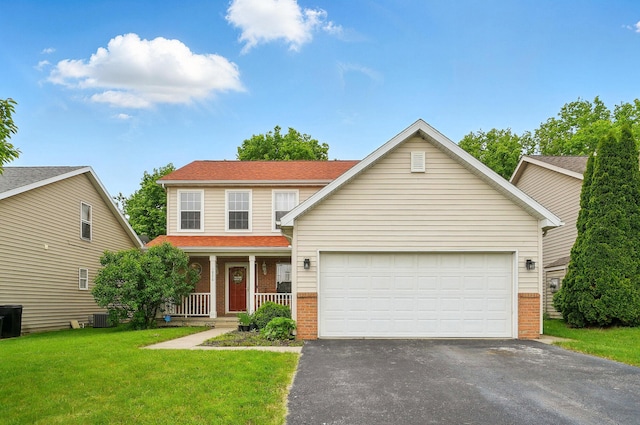1820 Bishop Ln, Findlay, OH 45840 - view of front facade with brick siding, driveway, covered porch, an attached garage, and a front lawn