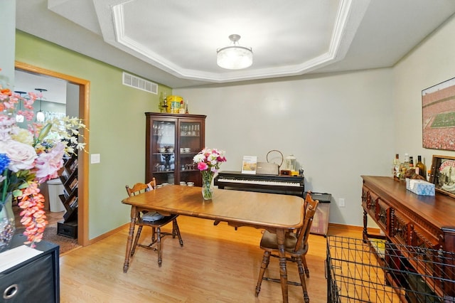 1820 Bishop Ln, Findlay, OH 45840 - dining area with light wood-style flooring, a tray ceiling, baseboards, and crown molding