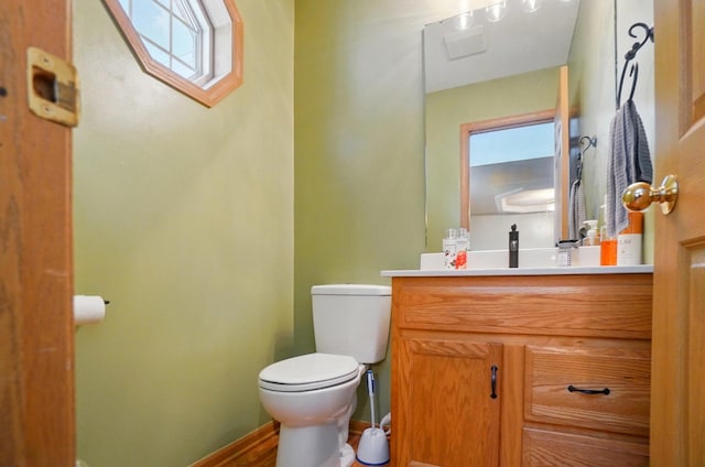1820 Bishop Ln, Findlay, OH 45840 - bathroom featuring toilet, vanity, baseboards, and wood finished floors