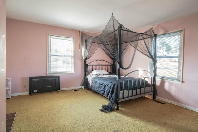 bedroom with baseboards and carpet floors