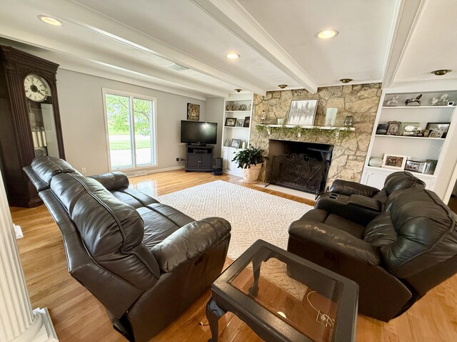 1337 Stratford Dr, Piqua, OH 45356 - living area with wood finished floors, a stone fireplace, beam ceiling, and recessed lighting